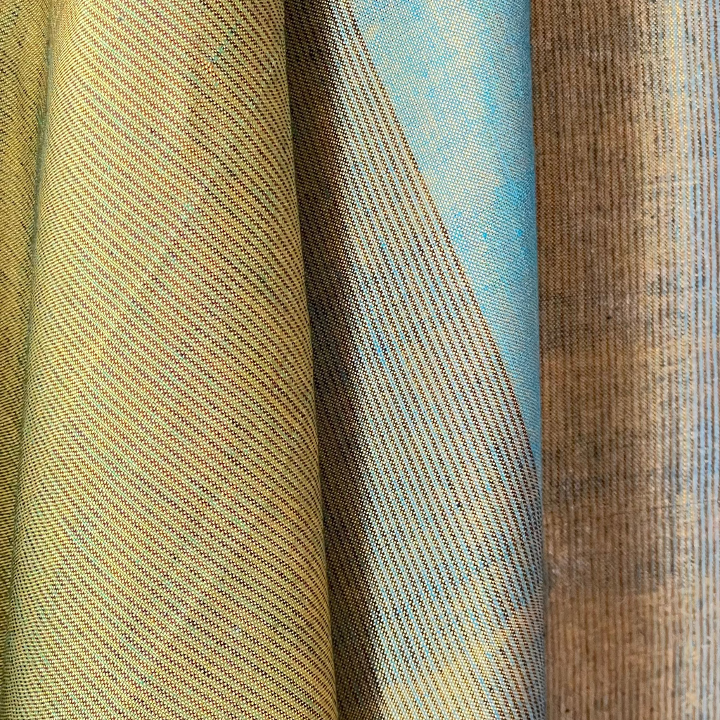 Close-up of fabric with a textured pattern in beige, blue, and brown.
