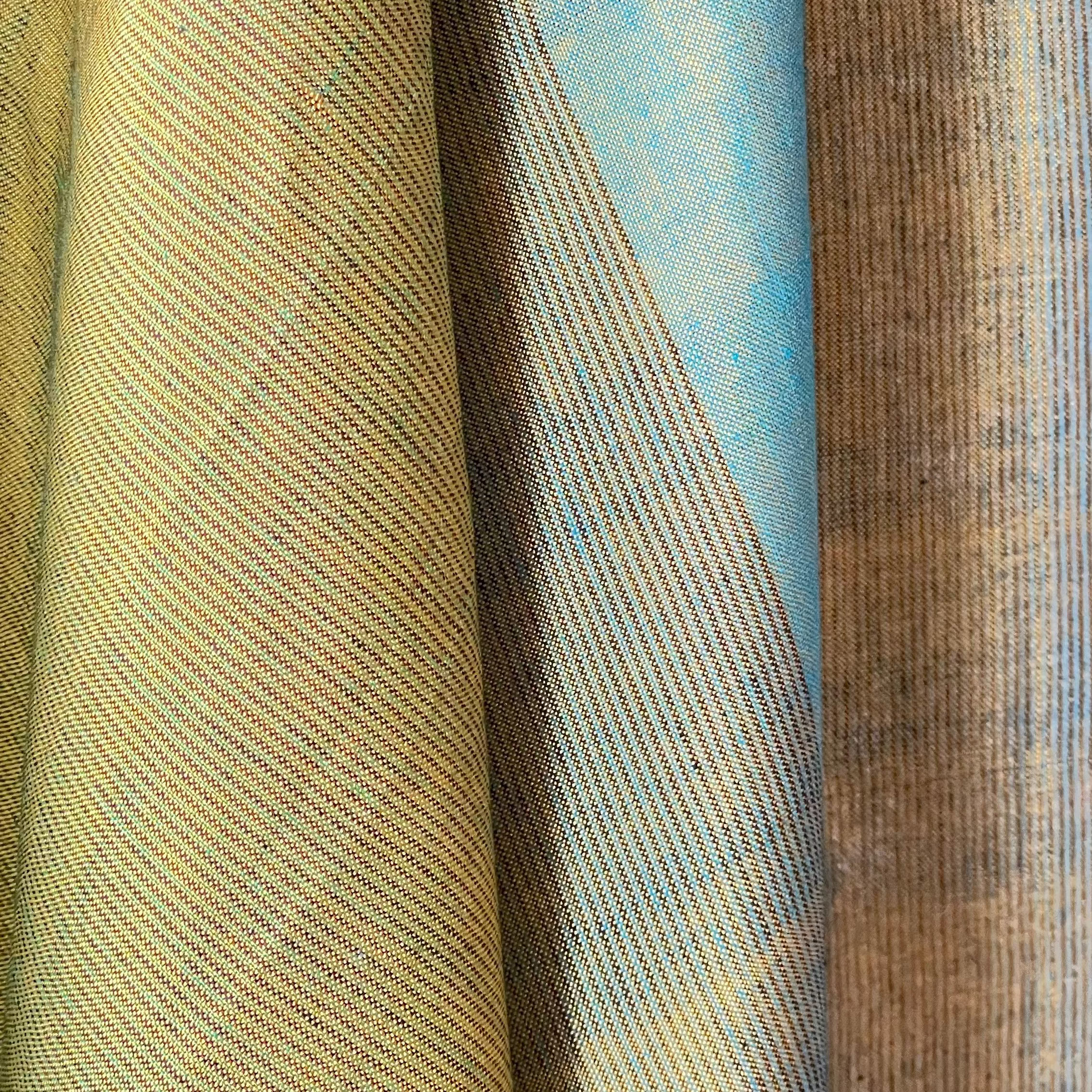 Close-up of fabric with a textured pattern in beige, blue, and brown.